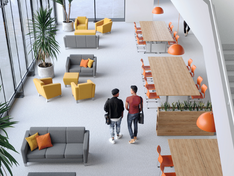 Common area with multiple tables and lounge areas featuring planters that divide the spaces.