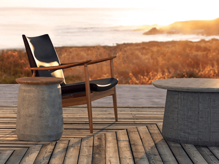 Outdoor lounge area featuring tables that combine the natural textures of concrete and wood.