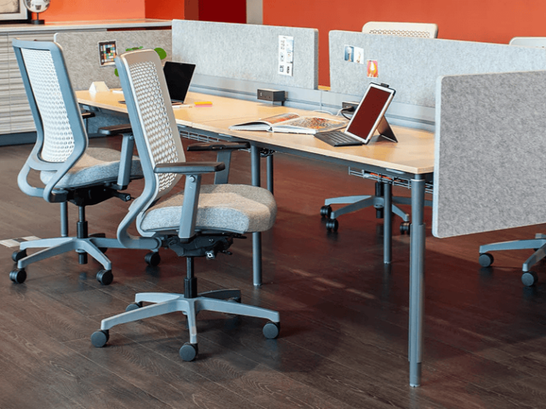 Workstations in an open office commercial design featuring rectangular desks with privacy panels.