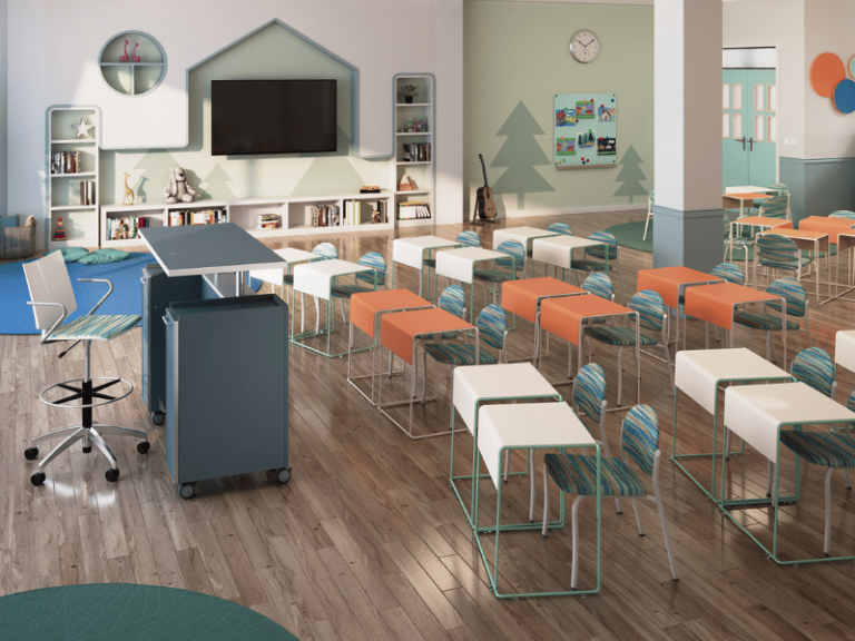 A children's classroom with a lectern in the front features colorful desks and chairs.