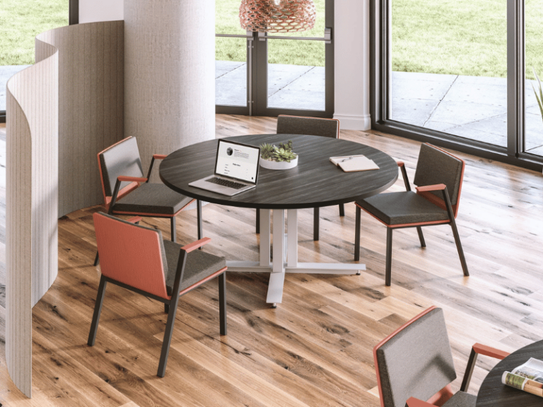 Round table with a dark wood grain top and four chairs.