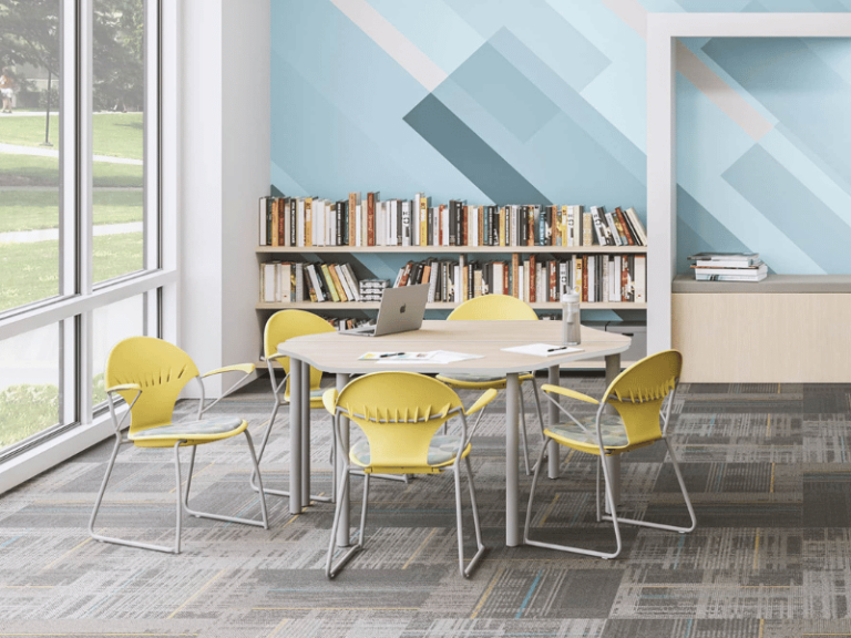 Yellow chairs at a table in a library.