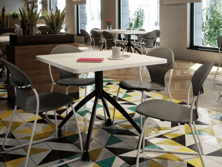 A dining area featuring white tables with gray round back chairs with a sled base.