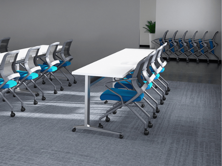 A classroom with white desks and nesting chairs that are on casters.